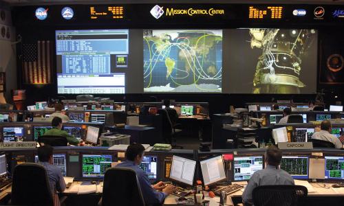 Employees at NASA's Johnson Space Center monitor a project on their computers