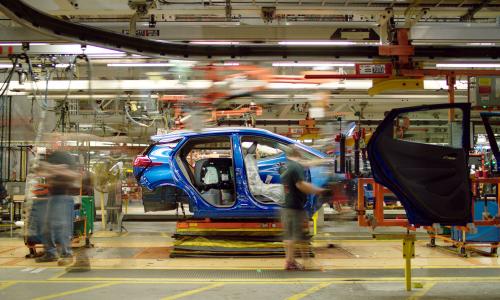 Electric vehicle being assembled in a factory