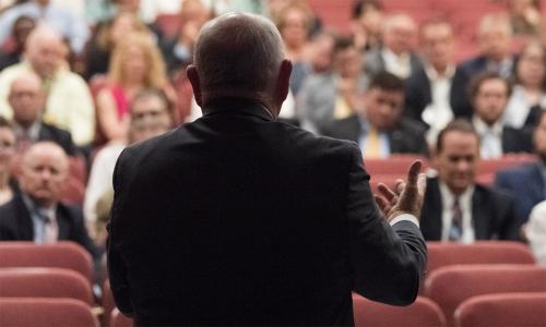 Sonny Perdue seen from behind speaking to an audience