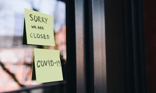 A closed sign on a store window.