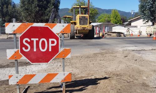 A stop sign in front of a construction site.