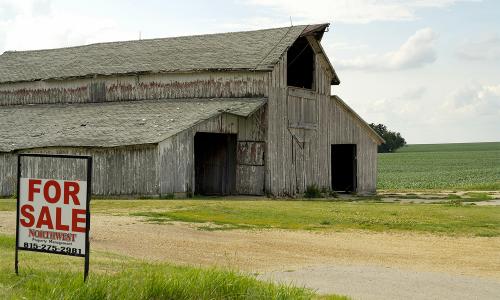 A For Sale sign outside a barn on a US farm