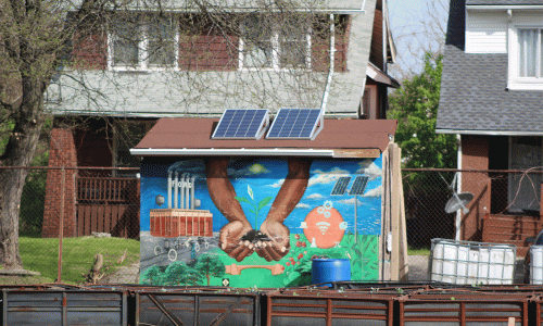 Mural with hands holding a plant in dirt