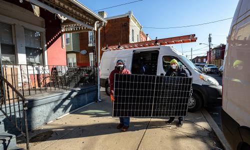 Some workers installing a solar panel