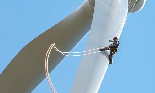 A worker rapelling of a wind turbine