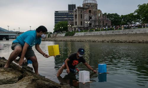 People floating paper lanterns on the Tenma River in Hiroshima, Japan.