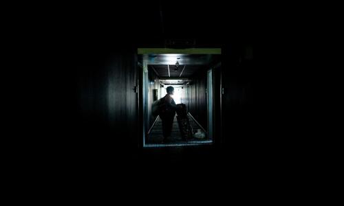 A family leaves a dark hotel.