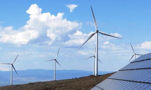 Wind turbines and solar panels on a hilltop