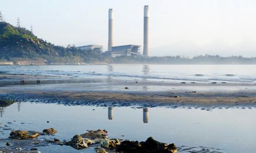 A power plant next to a river.